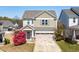 Charming two-story home with a landscaped front yard and neutral color palette at 36 Labradoodle Ct, Garner, NC 27529