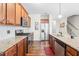Well-lit kitchen features stainless steel appliances, granite counters, and rich wood cabinets at 36 Labradoodle Ct, Garner, NC 27529