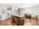 Open kitchen with island, stainless appliances, and a view of the dining area and staircase at 36 Labradoodle Ct, Garner, NC 27529