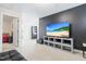 Cozy living room with a large TV and built-in shelving on a stylish black wall at 36 Labradoodle Ct, Garner, NC 27529