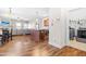 Open-concept living space with hardwood floors, modern furnishings, and a view of the laundry room at 36 Labradoodle Ct, Garner, NC 27529