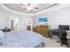 Bright main bedroom features a ceiling fan, media center, and access to bathroom and closet at 36 Labradoodle Ct, Garner, NC 27529