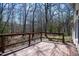 Wooden back deck with railings, offering a relaxing outdoor living space overlooking the serene backyard at 401 Joyce Rd, Hillsborough, NC 27278
