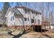 Exterior backyard view of a two-story home with a deck, brick foundation and siding at 401 Joyce Rd, Hillsborough, NC 27278