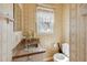 Cozy bathroom with vintage wallpaper, sink, and toilet in a compact space at 401 Joyce Rd, Hillsborough, NC 27278
