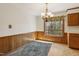 Cozy dining area with paneled walls, natural light, and traditional chandelier at 401 Joyce Rd, Hillsborough, NC 27278