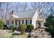 A charming home featuring a front porch with black shutters and complemented by mature trees at 401 Joyce Rd, Hillsborough, NC 27278