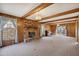 Spacious living room with a brick fireplace, wood paneling, and ample natural light at 401 Joyce Rd, Hillsborough, NC 27278