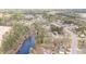 Aerial view of a neighborhood by a pond, showcasing lush trees and beautiful homes at 401 Molina Ct, Rolesville, NC 27571