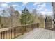 Spacious wood deck with wrought iron railing and views of the surrounding trees at 401 Molina Ct, Rolesville, NC 27571