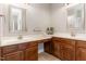 Bathroom featuring dual sinks, spacious counter-tops, and rich wood cabinetry at 401 Molina Ct, Rolesville, NC 27571