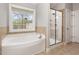 The bathroom boasts a large soaking tub and a glass-enclosed shower at 401 Molina Ct, Rolesville, NC 27571