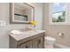 Bathroom with stylish vanity, framed mirror, and walk-in shower with a view at 401 Molina Ct, Rolesville, NC 27571
