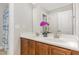 Bathroom featuring dual sinks, rich wood cabinetry, and a decorative flower at 401 Molina Ct, Rolesville, NC 27571