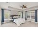Inviting bedroom features plush carpeting, blue drapes, and abundant natural light at 401 Molina Ct, Rolesville, NC 27571