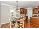 Cozy dining area with wood floors and pendant lighting beside the kitchen at 401 Molina Ct, Rolesville, NC 27571