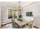 Dining room featuring natural light, modern chandelier, and neutral color palette at 401 Molina Ct, Rolesville, NC 27571