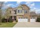 Charming two-story brick home featuring a three-car garage and manicured landscaping at 401 Molina Ct, Rolesville, NC 27571
