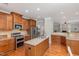 Gourmet kitchen boasts granite countertops, stainless steel appliances, and wooden cabinetry at 401 Molina Ct, Rolesville, NC 27571