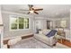 Comfortable living room featuring a ceiling fan and large windows overlooking greenery at 401 Molina Ct, Rolesville, NC 27571