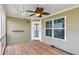 Covered porch with wooden decking and a ceiling fan at 401 Molina Ct, Rolesville, NC 27571