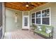 Relaxing covered porch features comfortable seating, ceiling fan, and inviting atmosphere at 401 Molina Ct, Rolesville, NC 27571