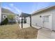 Backyard features a pergola, fence, some grass, and access to the home and garage at 416 Holding Creek Dr, Wake Forest, NC 27587
