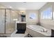 Bathroom featuring a soaking tub, glass enclosed shower, and dark wood vanity at 416 Holding Creek Dr, Wake Forest, NC 27587