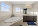 Bathroom with tub, dark cabinets, granite countertops, and tile flooring at 416 Holding Creek Dr, Wake Forest, NC 27587