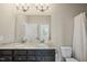 Elegant bathroom featuring double sinks with granite counters and a tiled shower-tub at 416 Holding Creek Dr, Wake Forest, NC 27587