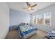 Inviting bedroom with blue walls, large window, and a plush bed with soft toys at 416 Holding Creek Dr, Wake Forest, NC 27587