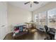 Bright bedroom featuring hardwood floors, natural light, and ample workspace with 2 tables at 416 Holding Creek Dr, Wake Forest, NC 27587