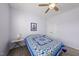 Bedroom with lilac walls and ceiling fan showcases a comfy quilted bed and artwork at 416 Holding Creek Dr, Wake Forest, NC 27587