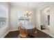 Dining room with hardwood floors, modern lighting and a view to the front yard at 416 Holding Creek Dr, Wake Forest, NC 27587