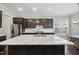Modern kitchen featuring granite countertops, stainless steel appliances, and dark wood cabinets at 416 Holding Creek Dr, Wake Forest, NC 27587