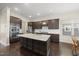 Spacious kitchen featuring a granite island, stainless steel appliances, and dark wood cabinets at 416 Holding Creek Dr, Wake Forest, NC 27587