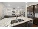 Modern kitchen with granite counters, stainless appliances, and an open view to the living room at 416 Holding Creek Dr, Wake Forest, NC 27587