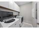 Modern laundry room featuring front load washer and dryer with white cabinets at 416 Holding Creek Dr, Wake Forest, NC 27587