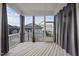 Spacious screened-in porch with white wooden floors and views of a well-kept backyard at 416 Holding Creek Dr, Wake Forest, NC 27587