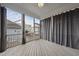 Bright screened porch with light wood floors, neutral curtains and views of the backyard at 416 Holding Creek Dr, Wake Forest, NC 27587