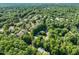 Overhead view of condo community surrounded by vibrant greenery, with amenities like a pool and tennis courts, creating an appealing lifestyle at 4601 Timbermill Ct # 302, Raleigh, NC 27612