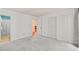 Spacious bedroom with neutral carpet, white walls, double closets, and open doorway to hallway at 4601 Timbermill Ct # 302, Raleigh, NC 27612