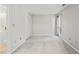 Neutral bedroom with closet, window, and adjoining bathroom at 4601 Timbermill Ct # 302, Raleigh, NC 27612