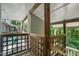 Wooden deck with railing showing partial view of another deck with table, chair, and stairwell at 4601 Timbermill Ct # 302, Raleigh, NC 27612