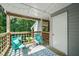 Inviting deck with two blue chairs, table with plants, wooden railings, and overhead string lights at 4601 Timbermill Ct # 302, Raleigh, NC 27612