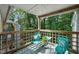 Charming deck with two chairs, table, wooden railing, and tree-lined view creates a cozy outdoor space at 4601 Timbermill Ct # 302, Raleigh, NC 27612