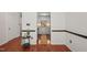Clean entryway with hardwood floors leading to a kitchen with gray cabinets at 4601 Timbermill Ct # 302, Raleigh, NC 27612