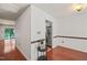 Entryway with hardwood floors leading to a kitchen with stainless steel refrigerator at 4601 Timbermill Ct # 302, Raleigh, NC 27612