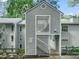 Condo exterior showcasing grey siding, white lattice, and unit numbers, presenting a well-maintained and appealing entrance at 4601 Timbermill Ct # 302, Raleigh, NC 27612