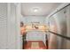 Modern kitchen with white cabinets, stainless steel appliances, and hardwood floors at 4601 Timbermill Ct # 302, Raleigh, NC 27612